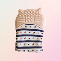 Reverse side of pink raccoon teething mitt on white background