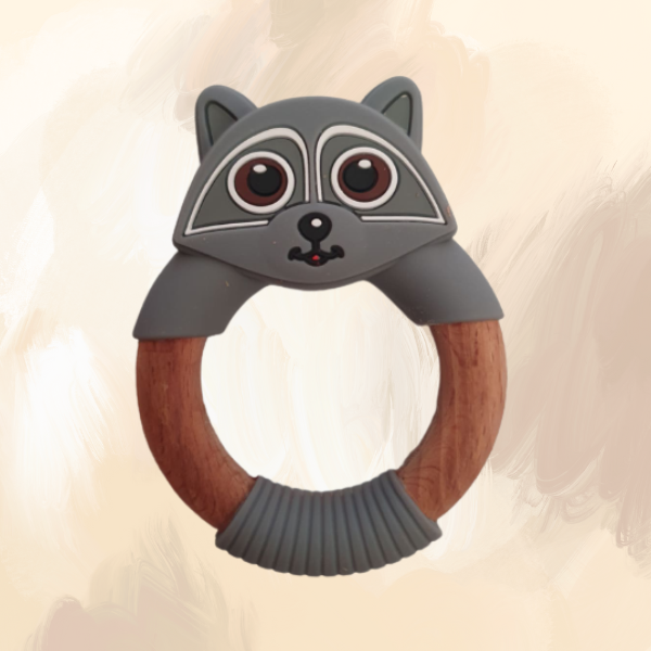 A grey silicone teething ring designed to resemble a raccoon, with a wooden central ring.
