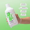 Hand holding a bottle of noody body wash with green background and product benefits listed.