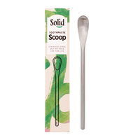 Solid Toothpaste Scoop with packaging on a white background