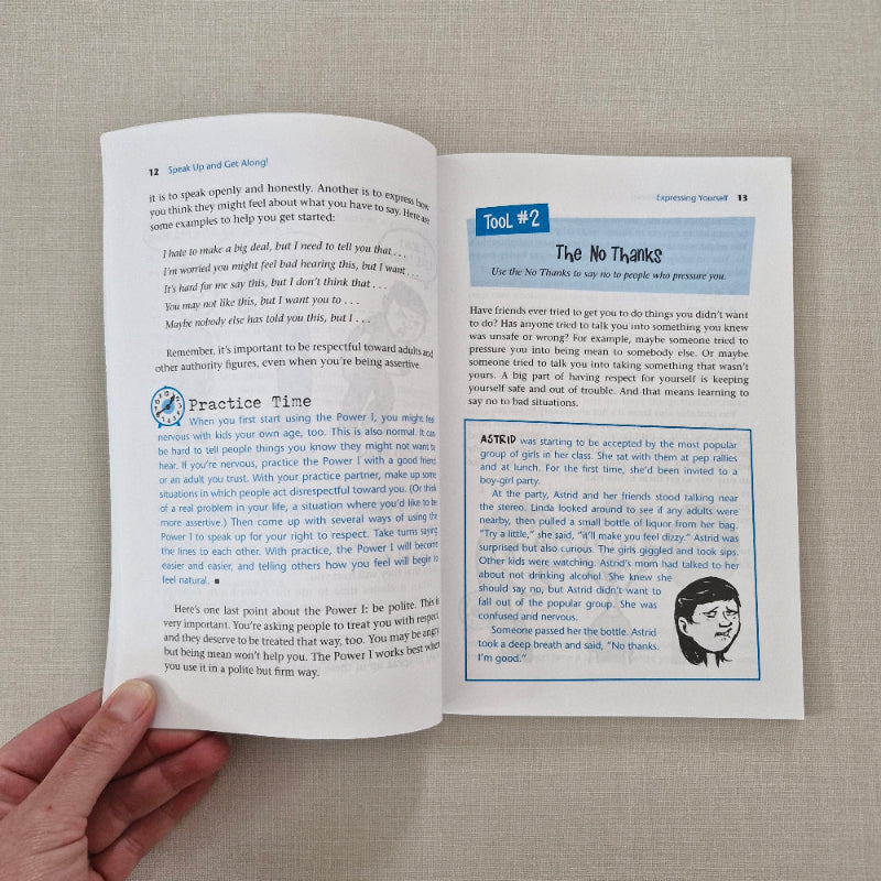 Open book with text and a hand holding it on a textured surface