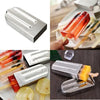 Metallic ice pop mold with popsicles and ice cubes on a wooden surface.