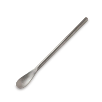 Stainless toothpaste scoop on a white background