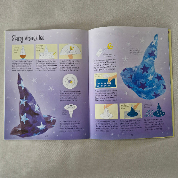 Open book showing illustrations of a wizards hat with star patterns on a purple background.