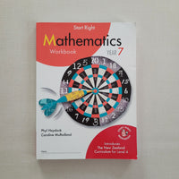 Mathematics workbook with dartboard design on a plain background