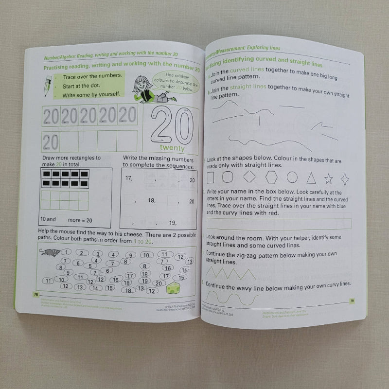 Open book with mathematics educational content on a plain background