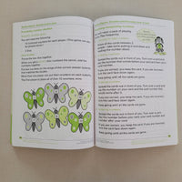 Open maths book with butterfly illustrations on a beige background