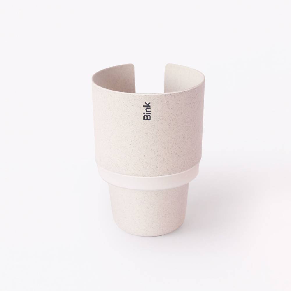 Straw coloured car cup holder with white accent on a white background