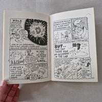 Open book with black and white illustrations on a grey fabric background