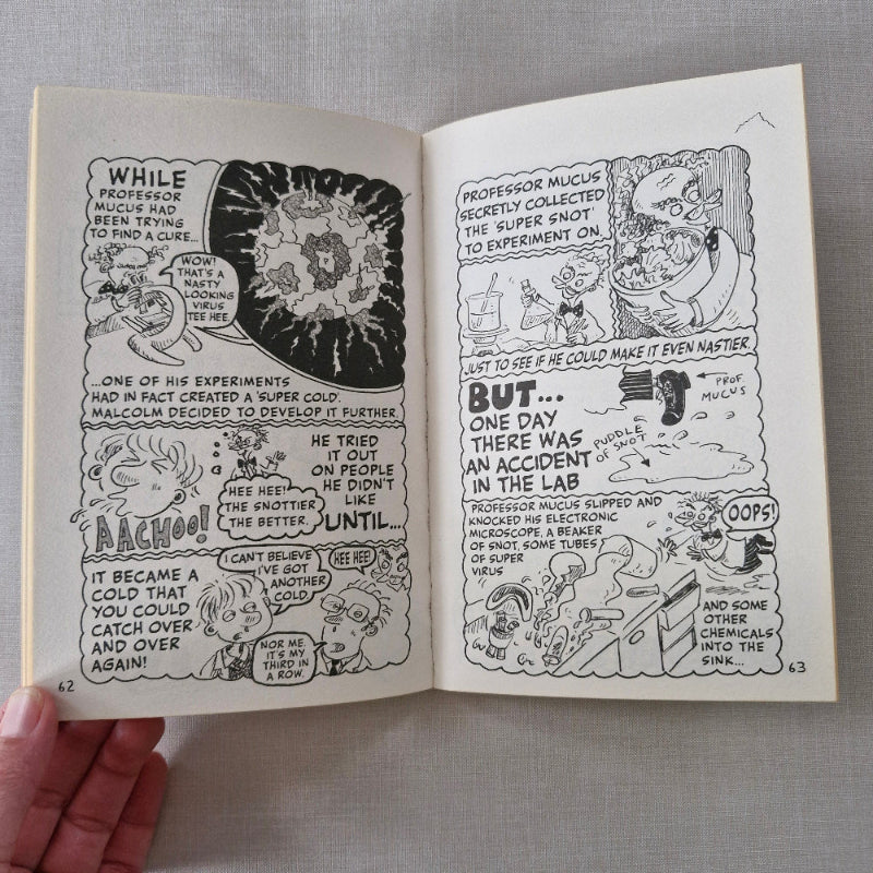 Open book with black and white illustrations on a grey fabric background