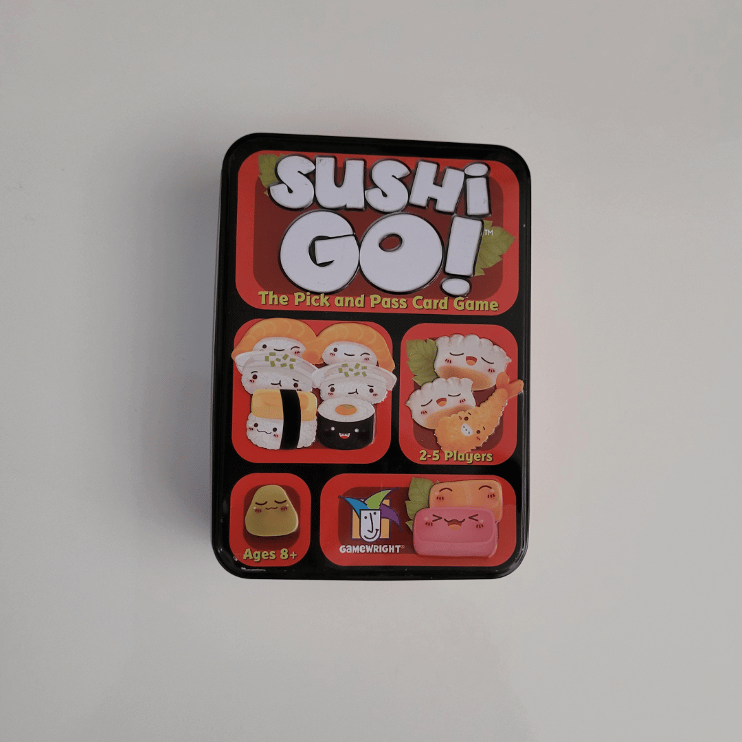 Sushi Go! card game tin on a light grey background
