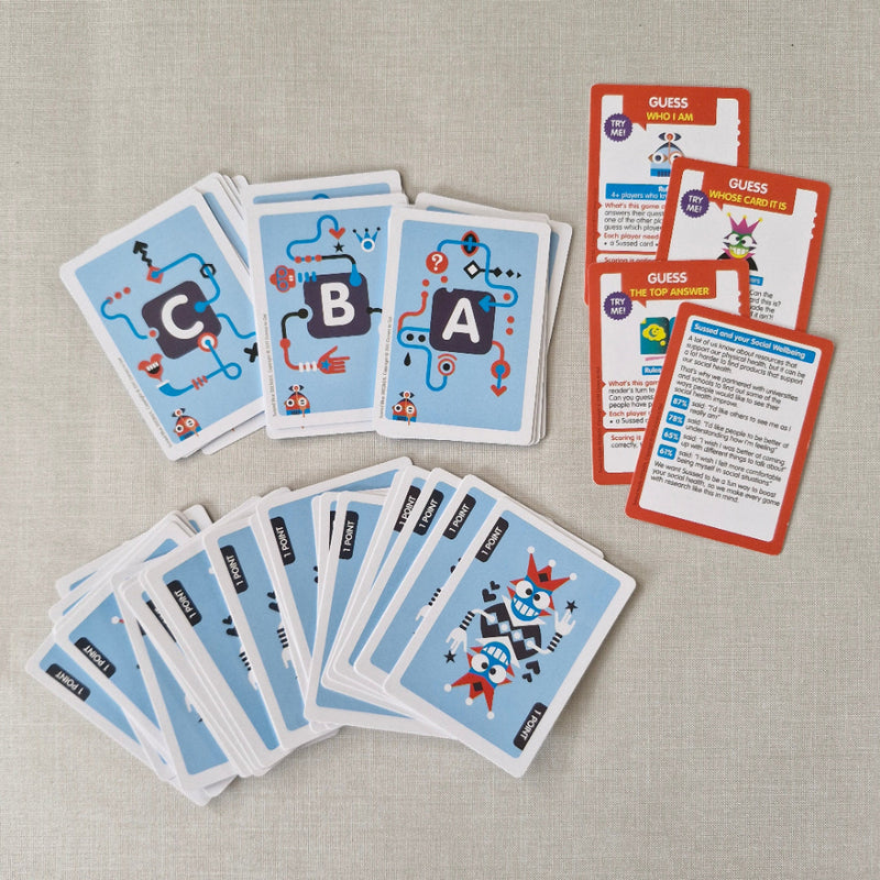 Stacks of educational cards with letter designs on a textured surface