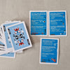 Card game with blue question cards and a stack of cards on a textured surface