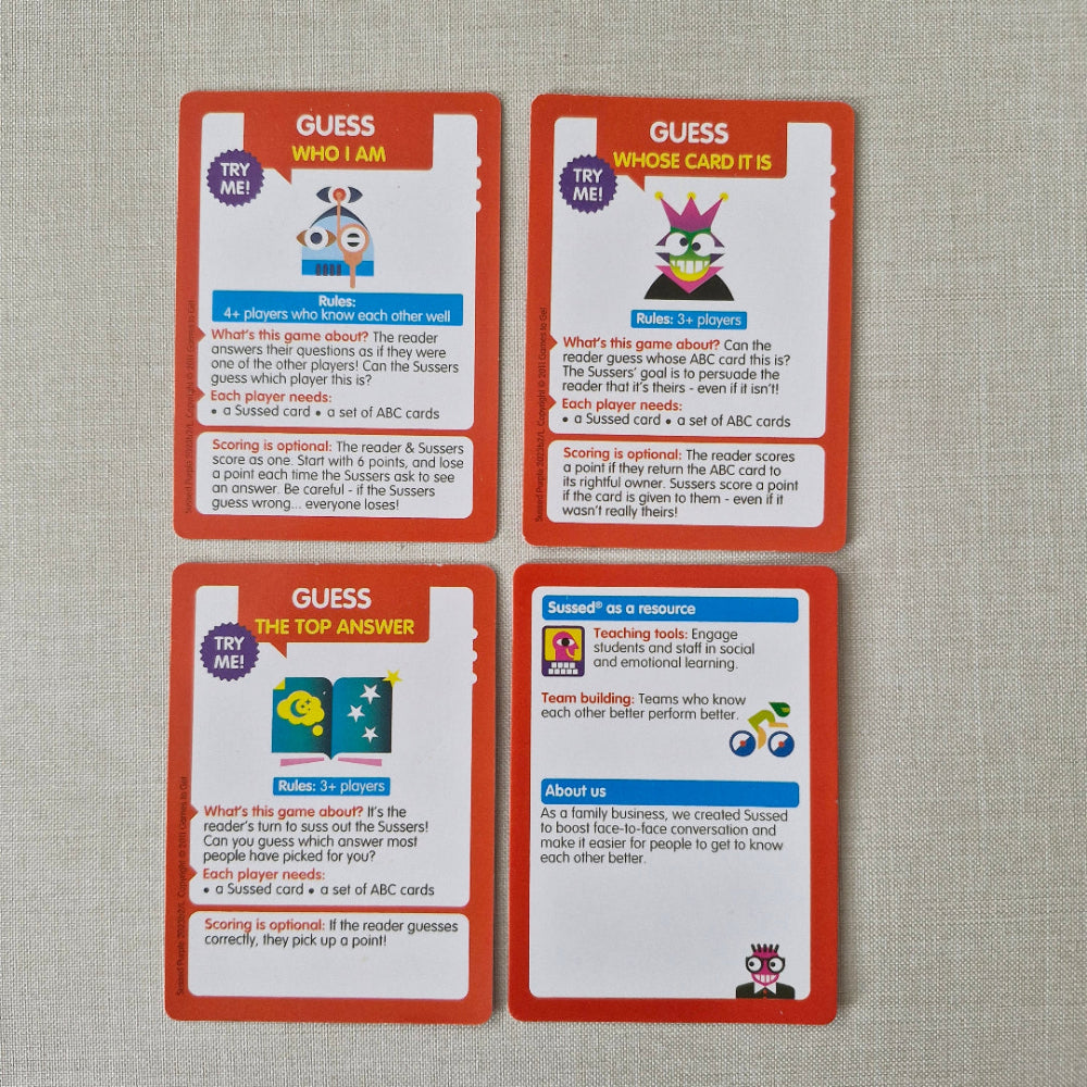 Four educational cards with colourful graphics and text on a textured grey surface