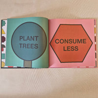 Open book with 'Consume Less' and 'Plant Trees' text on a beige background