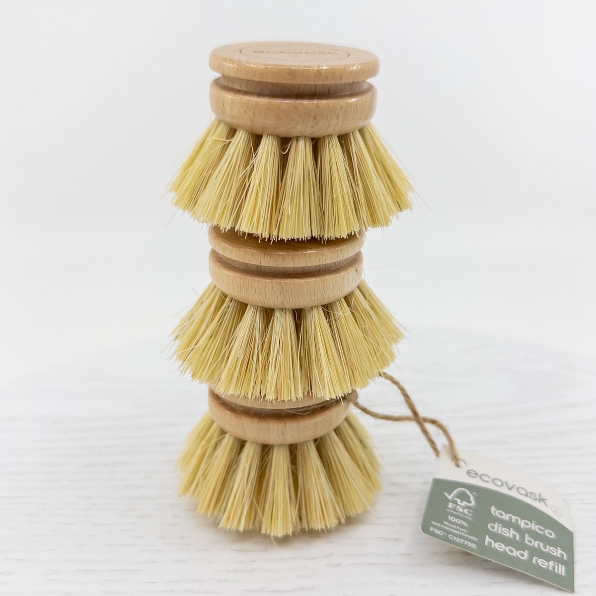 Three dish brush refill heads stacked together on white background 