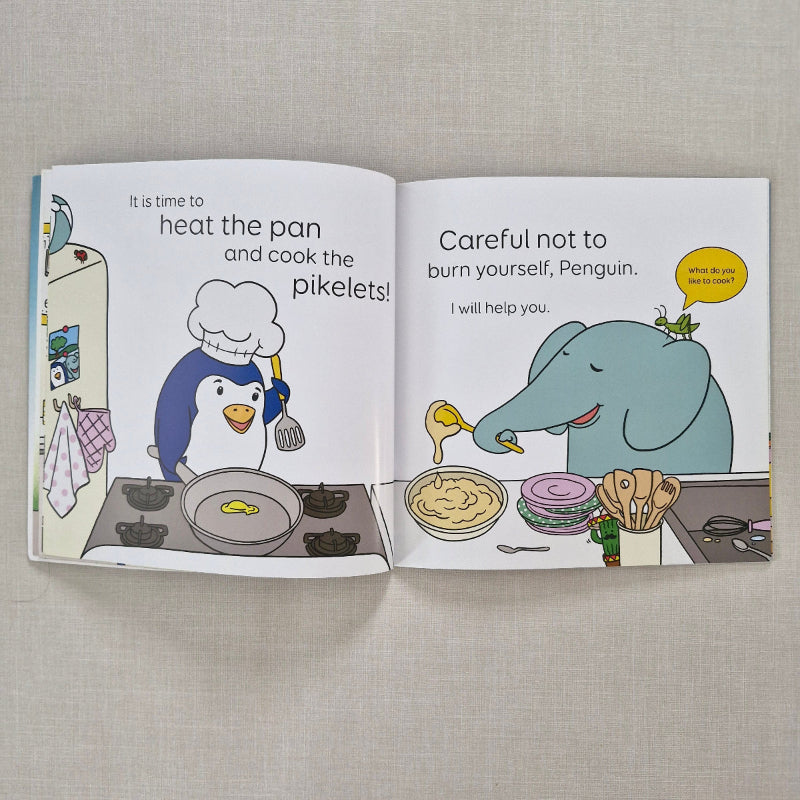 Open book with cartoon illustrations of an elephant and penguin on a textured surface