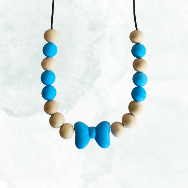 Teething necklace with blue and beige beads and a bow on a white background