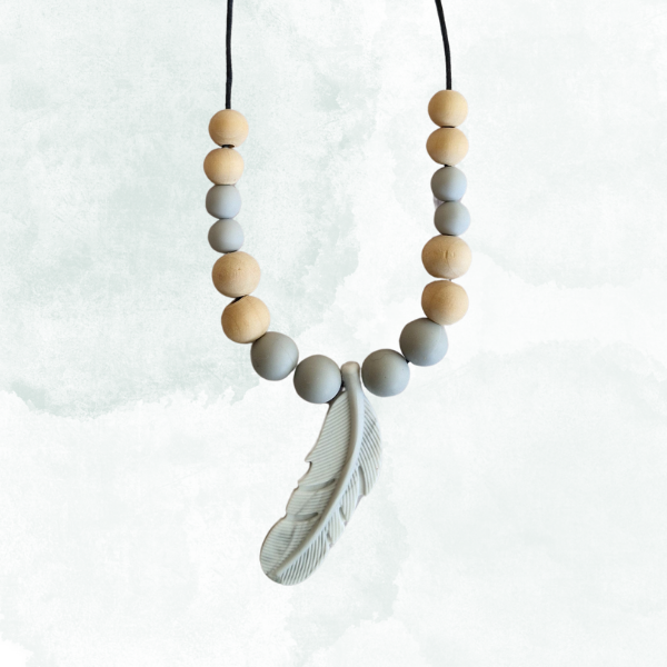 Necklace with wooden and gray beads and a feather pendant on a white background