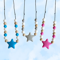Colorful star-shaped necklaces with beads against a blue sky background