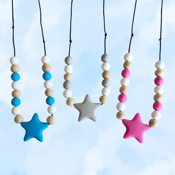 Colorful star-shaped necklaces with beads against a blue sky background