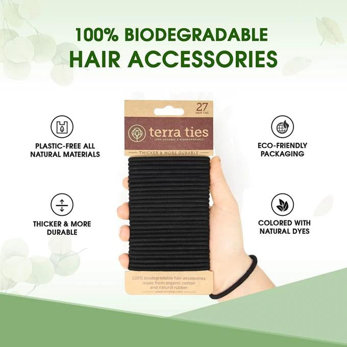 A pack of 27 black hair ties labeled as 100% biodegradable hair accessories, with packaging that emphasizes eco-friendly and plastic-free attributes.