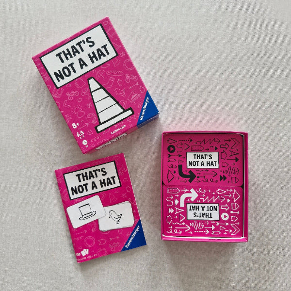 Pink box with 'THAT'S NOT A HAT' text and graphics on a light gray background