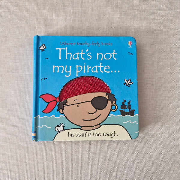 Children's book titled 'That's not my pirate' on a textured surface