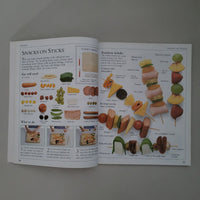 Open book showing illustrations of snacks on sticks with text and images.