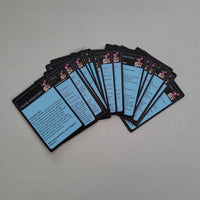Set of science tricks cards with blue backs and black borders on a gray surface