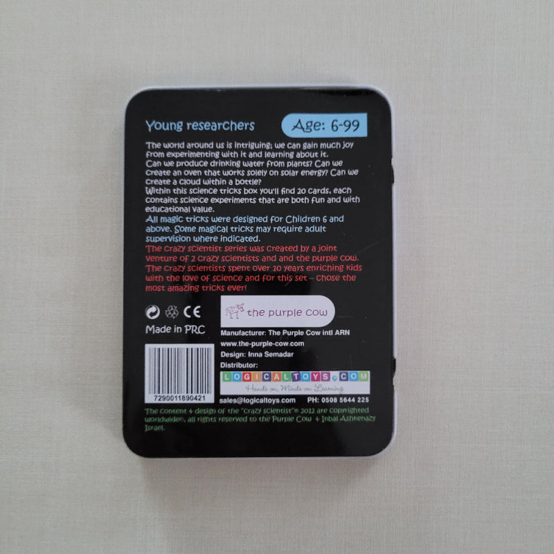 Black rectangular tin with text and labels on a light gray background