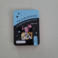 Tin titled 'The Crazy Scientist' with a cartoon character on a gray surface