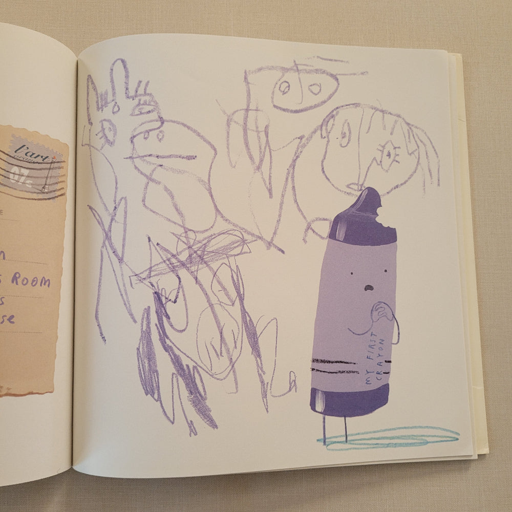 An open sketchbook or art book showing a childlike purple drawing of a bottle and scribbled figures on cream pages, with a torn beige paper fragment visible at the bottom.