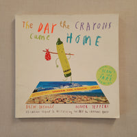The Day the Crayons Came Home children's book by Drew Daywalt and Oliver Jeffers, featuring a cream-coloured cover with colorful hand-drawn title text and an illustration of a crayon holding a red polka-dot bag. A green circular sticker on the right says 'Contains Special Slow Art Drawing.