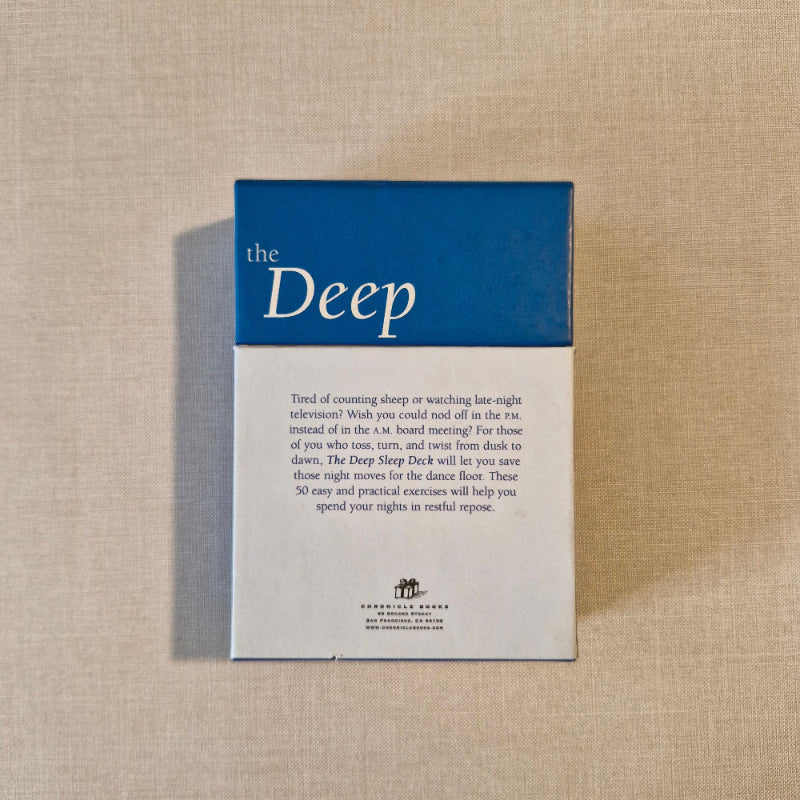 Book titled 'the Deep' on a textured beige surface