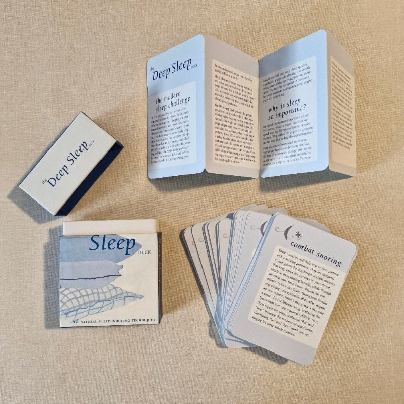 Sleep-themed cards and booklets on a beige fabric background