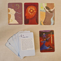 Set of cards with artistic designs on a beige fabric background