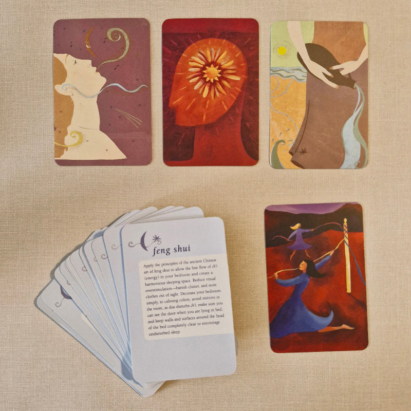 Set of cards with artistic designs on a beige fabric background
