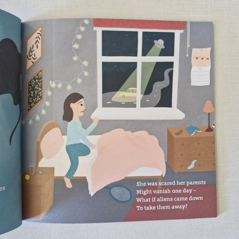 Open book with illustration of a girl looking out a window