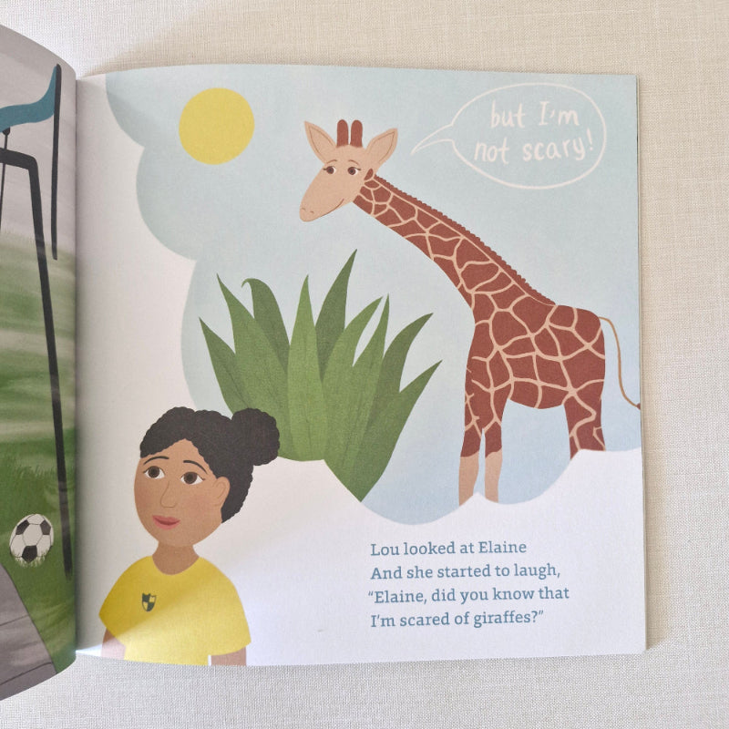 Children's book open to a page with an illustration of a child and a giraffe.