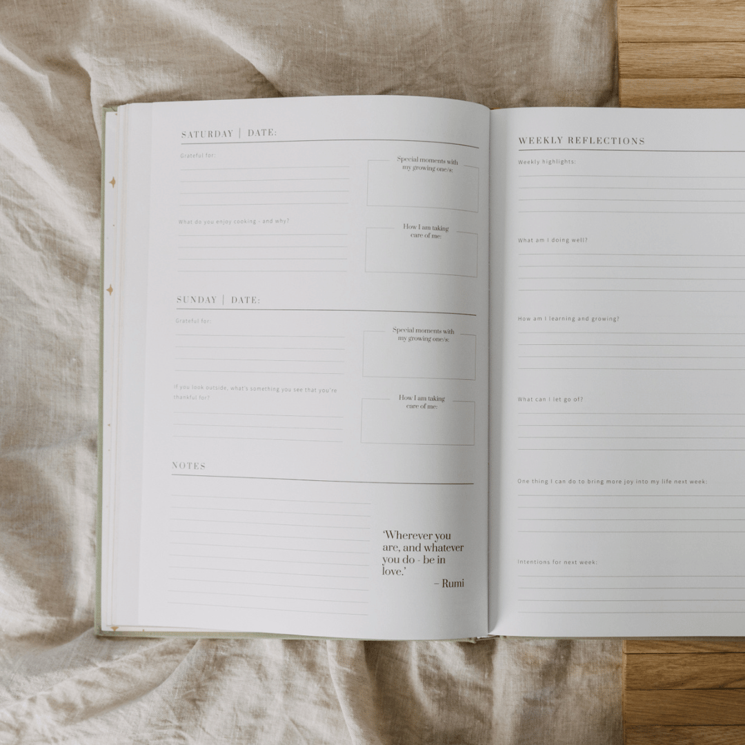 Open planner with daily reflections and notes on a textured fabric surface
