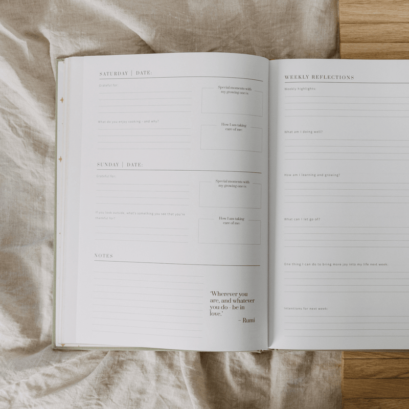 Open planner with daily reflections and notes on a textured fabric surface