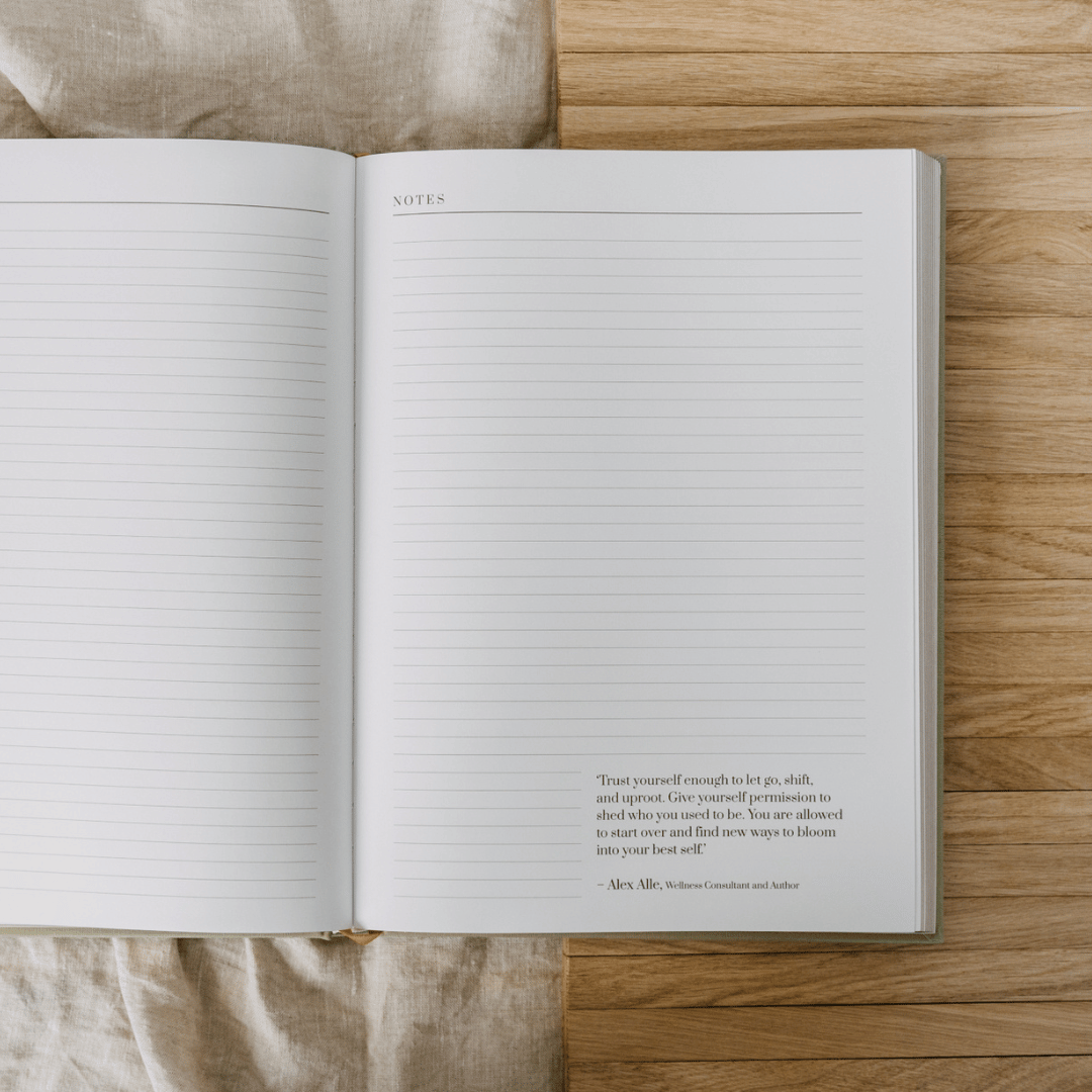 Open notebook with lined pages on a wooden surface