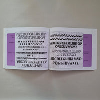 Two book pages with letter fonts templates on a plain background