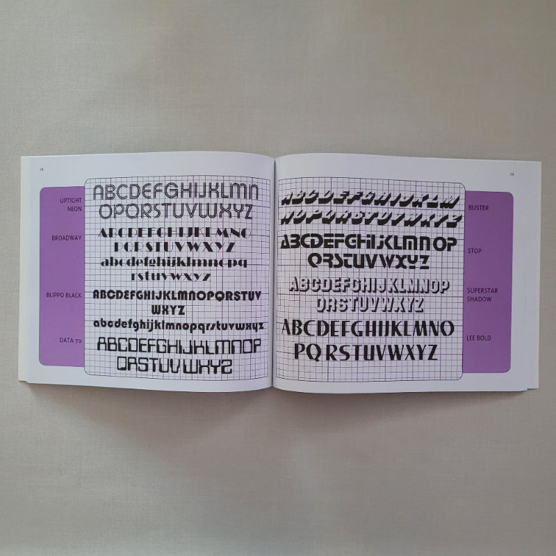 Two book pages with letter fonts templates on a plain background