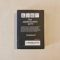 Black box of 'the MINDFULNESS game' by Innercoins on a beige fabric background