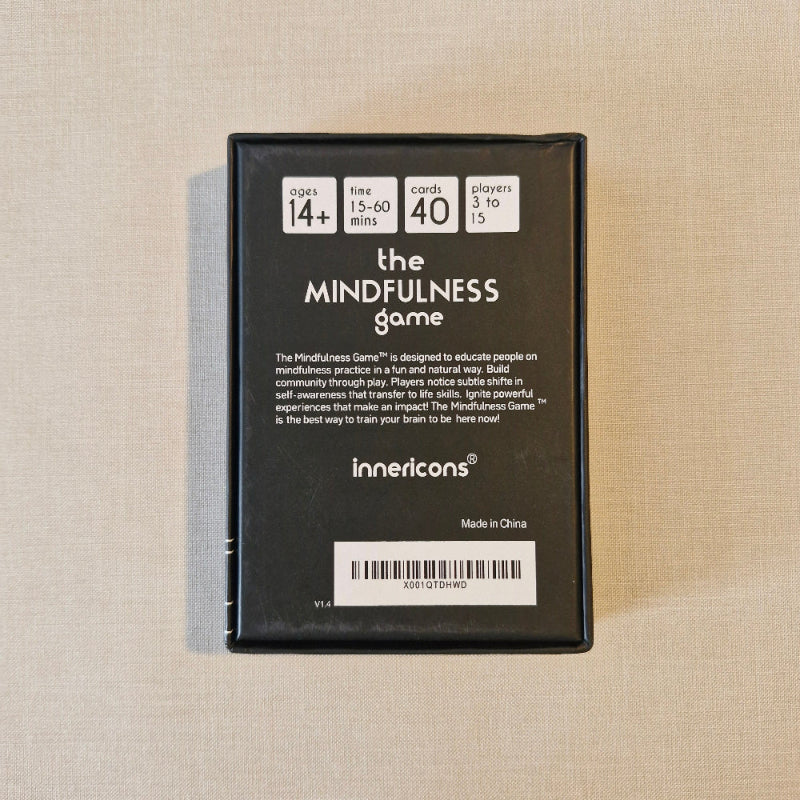 Black box of 'the MINDFULNESS game' by Innercoins on a beige fabric background