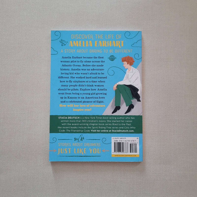 Book cover with a blue background and text on a gray surface