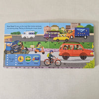 Children's book with illustrated vehicles on a beige surface