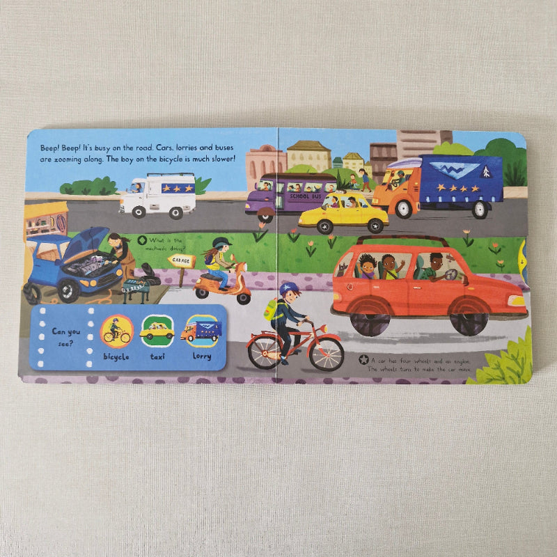 Children's book with illustrated vehicles on a beige surface